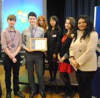 Clive Williams handing the trophy to  Goda Norvilaite, President of Springwood High School Interact Club.